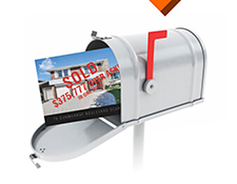 A Just Sold real estate postcard in a mailbox