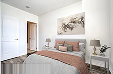 The same bedroom after virtual staging, furnished with a bed, nightstands, lamps and wall art